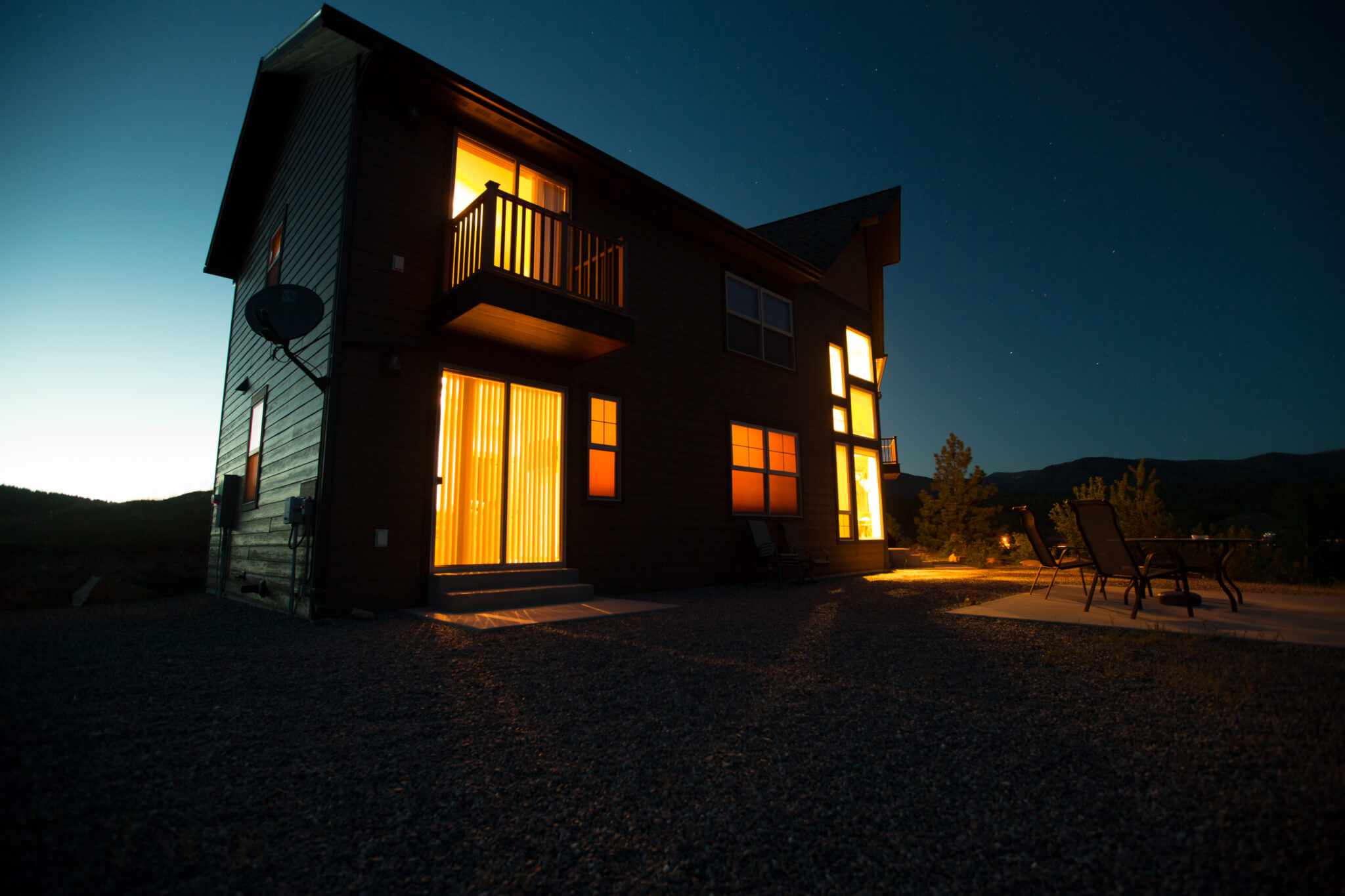 Exterior of large fishing lodge at night.