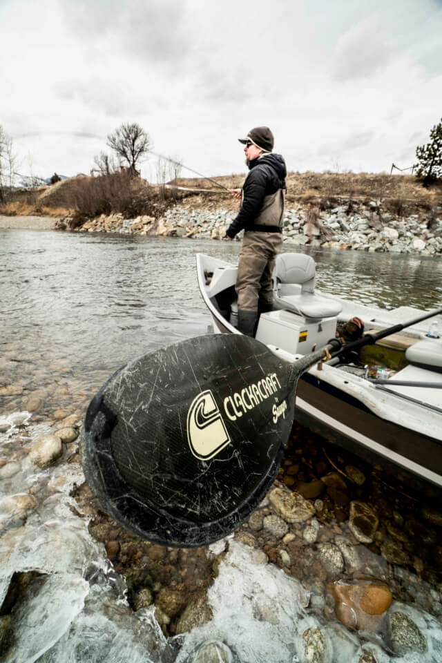 Person in boat casting fishing line.