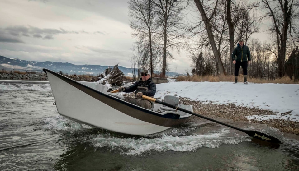 Person rowing fishing boat.